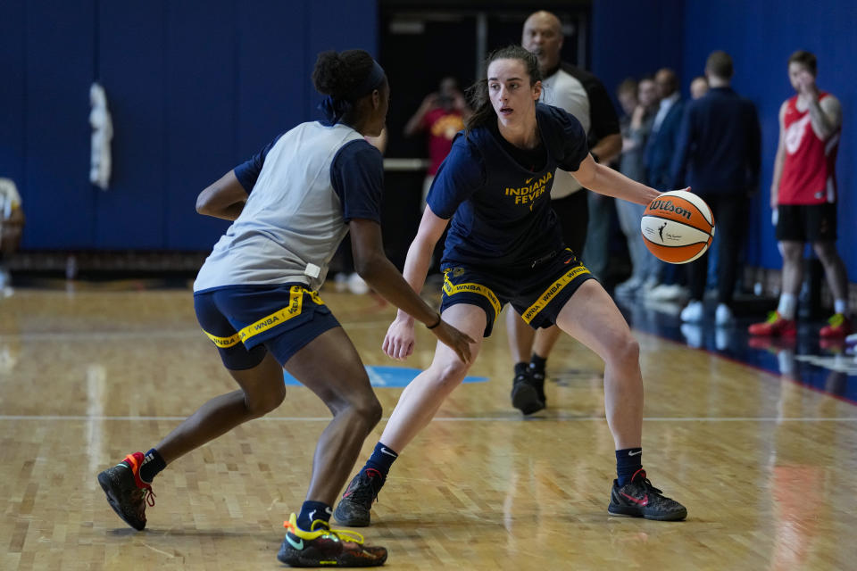 Indiana Fever guard Maya Caldwell, left, defends against guard Caitlin Clark, front right, as the WNBA basketball team practices in Indianapolis, Sunday, April 28, 2024. (AP Photo/Michael Conroy)