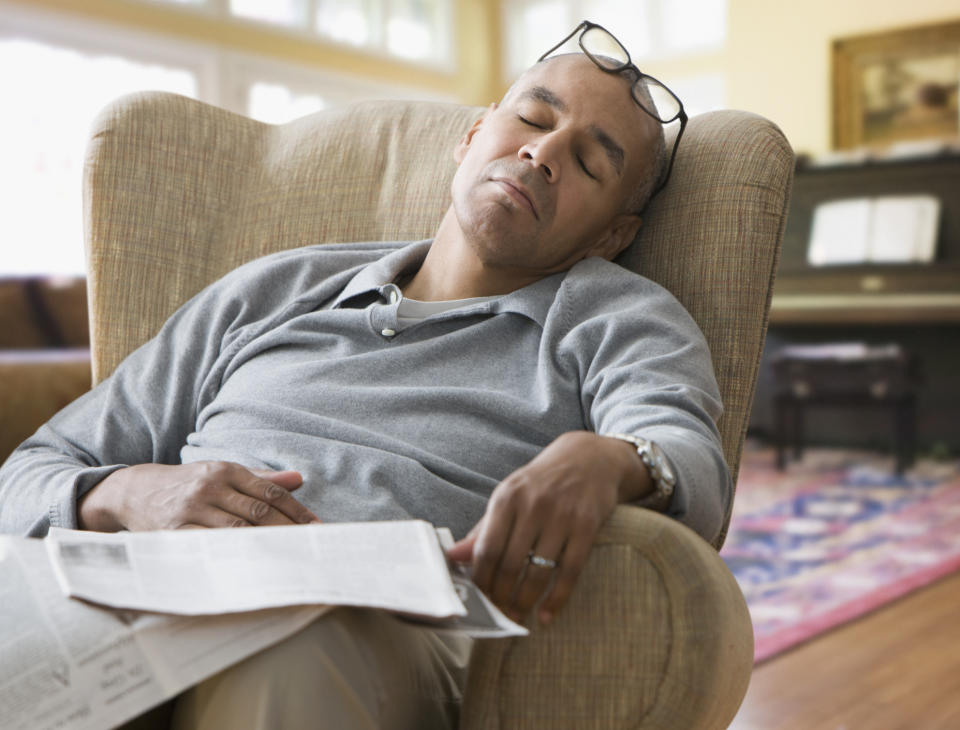 person asleep on their living room chair