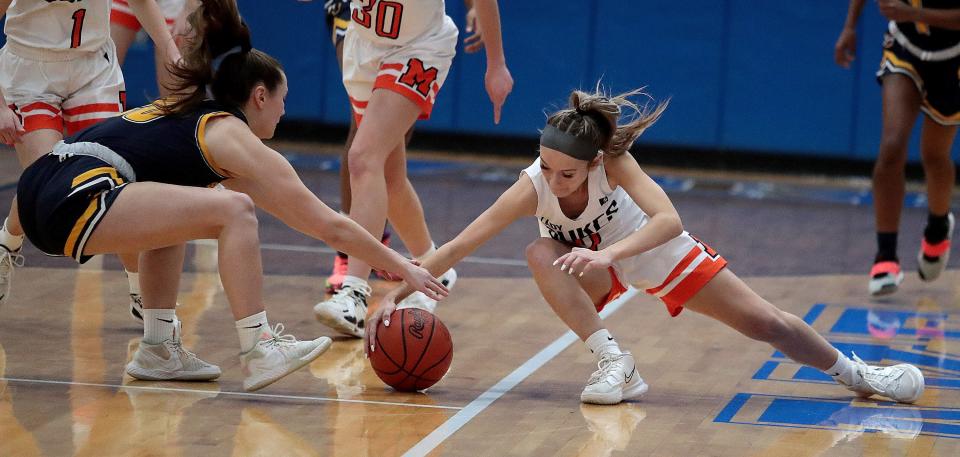Streetsboro's Mallory Rice ,left, and Marlington's Kenna McElroy fight for a loose ball in the first half at Lake High Wednesday, Feb. 23, 2022.