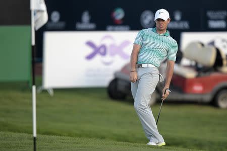 Rory McIlroy of Northern Ireland watches his shot on the 18th green during the second round of the DP World Tour Championship in Dubai November 21, 2014. REUTERS/Nikhil Monteiro