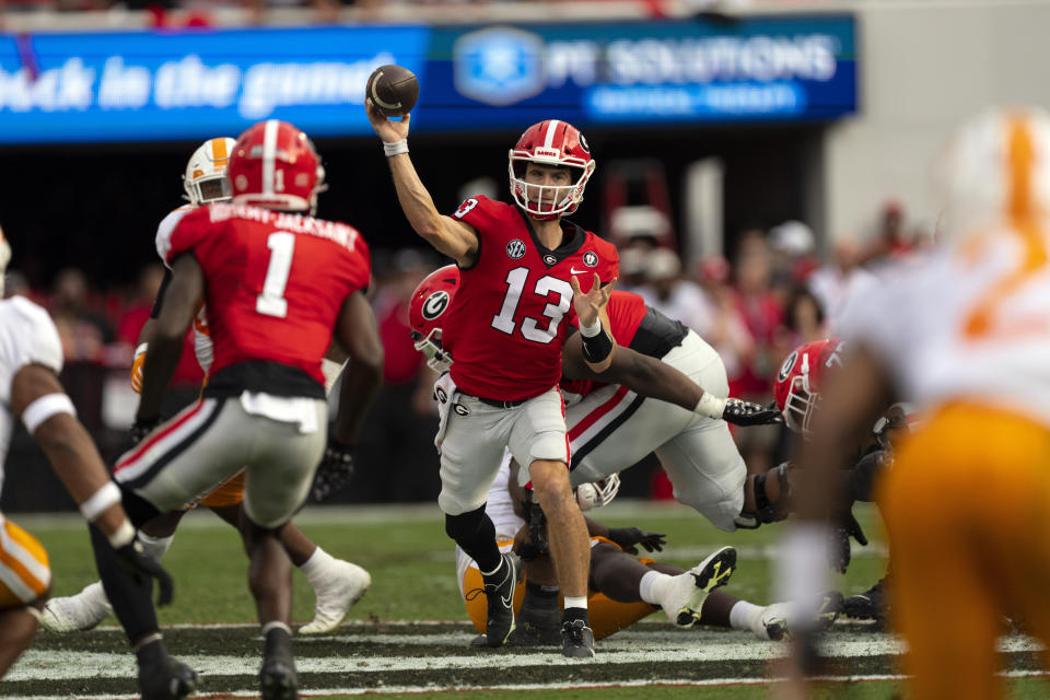 Georgia quarterback Stetson Bennett (13) throws from the pocket during the first half of an NCAA college football game against Tennessee, Saturday, Nov. 5, 2022 in Athens, Ga. (AP Photo/John Bazemore)