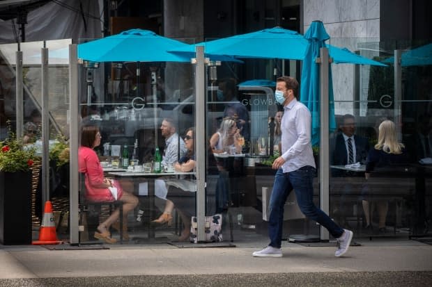 Diners are pictured eating at a restaurant in downtown Vancouver, British Columbia on Tuesday, June 22, 2021.  (Ben Nelms/CBC - image credit)