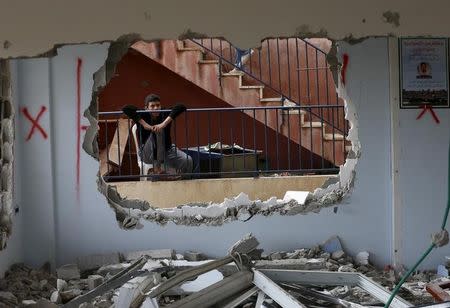 A relative looks at the demolished house of Palestinian Bahaa Mohammed Halil Allyan in the Arab east Jerusalem neighbourhood of Jabel Mukaber January 4, 2016. REUTERS/Ammar Awad