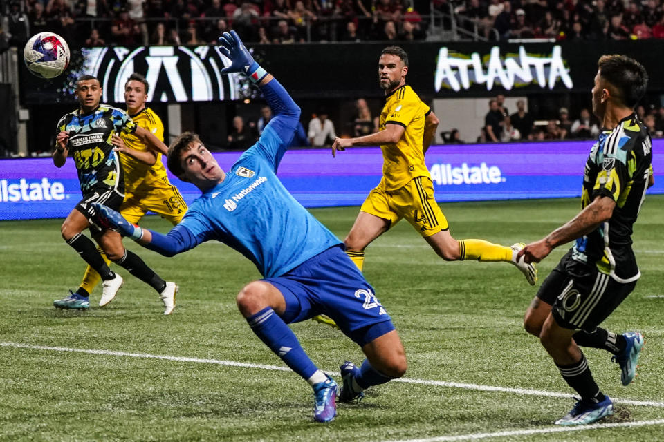 Columbus Crew goalkeeper Patrick Schulte (28) misses the ball as Atlanta United's Thiago Almada (10) scores the goal during the second half of an MLS playoff soccer match, Tuesday, Nov. 7, 2023, in Atlanta. (AP Photo/Mike Stewart)