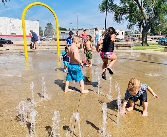 Children playing as part of the Salina Public Library June program at Hawthorne Park splash pad.
