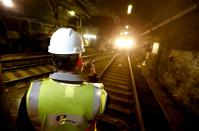 John Burkhard, assistant superintendent for the Way and Structures Division of the Port Authority Trans-Hudson train line, talks on a radio as a PATH train approaches in the tunnel, Tuesday, Nov. 27, 2012, in Hoboken, N.J. While parts of the trans-Hudson service have gradually returned to service since Superstorm Sandy, the Hoboken station has been closed, leaving thousands of commuters to seek alternatives. (AP Photo/Julio Cortez)