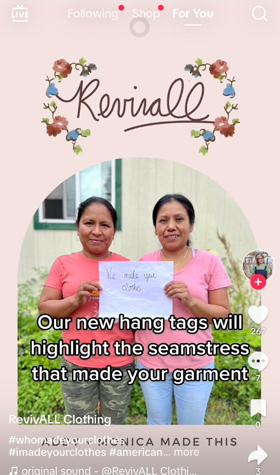 Two women holding a sign promoting new hangtags showcasing the origin of clothing