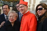 Philippines' Luis Antonio Tagle poses with his family after the ceremony at which he was appointed a cardinal at St Peter's basilica at the Vatican on Saturday., a move welcomed by critics concerned that the body which will elect the future pope is too Eurocentric. AFP PHOTO / VINCENZO PINTO