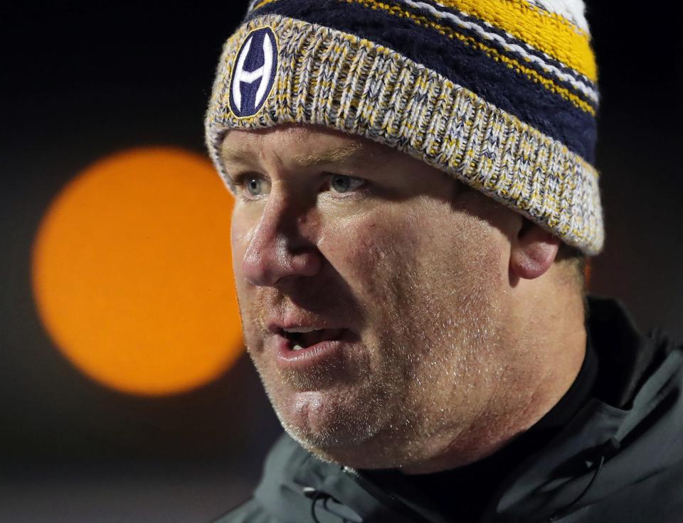 Hoban football coach Tim Tyrrell speaks to his team after beating Nordonia 35-7 in a Division II regional semifinal, Friday, Nov. 12, 2021, in Ravenna.