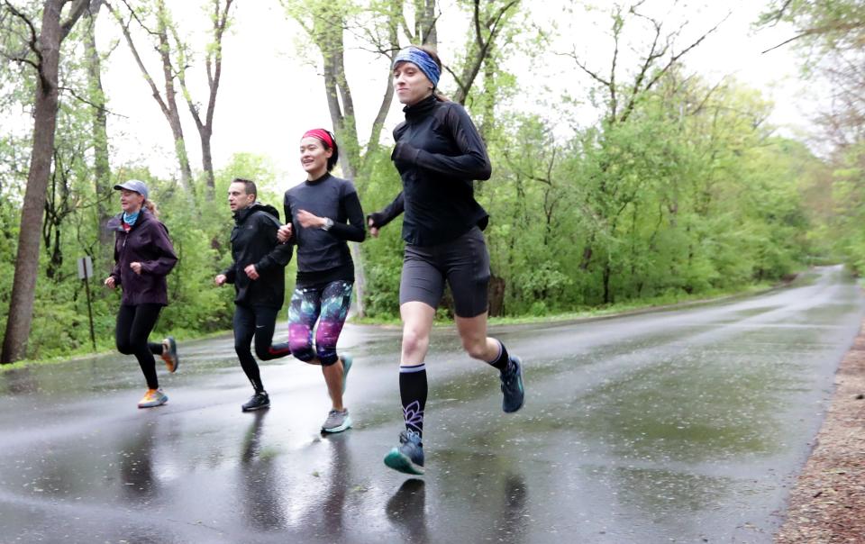 Emma Cameron, far right, runs with friends in a running club including, from far left, Britta Welsch, Nathan Dowd, and Lin Zhao at the University of Wisconsin-Madison Arboretum in Madison on Thursday, May 6, 2021.