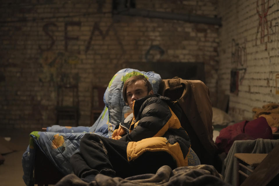 A boy lies on a makeshift bed in a shelter in the basement of an apartment building during the shelling of a power and heating plant in Shchastya, in the Luhansk region, eastern Ukraine, Tuesday, Feb. 22, 2022. Russian President Vladimir Putin has asked the country’s parliament for permission to use military force outside the country. That could presage a broader attack on Ukraine after the U.S. said an invasion was already underway there. (AP Photo/Vadim Ghirda)