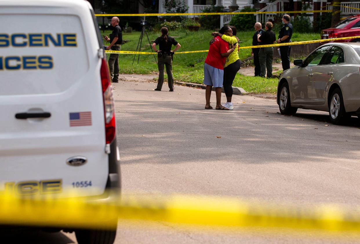 A person is consoled in the street as Springfield police investigate a homicide in the 2500 block of South 10th Street in Springfield on Aug. 9. Three victims died of multiple shotgun wounds at a residence in the 2500 block of South 10th Street. Two men from Jacksonville have arrested in connection to the case. [Justin L. Fowler/The State Journal-Register]