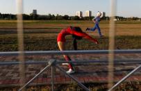 A woman stretches after her show on the stage outside the stadium in Kaliningrad, Russia, June 28, 2018. REUTERS/Kacper Pempel