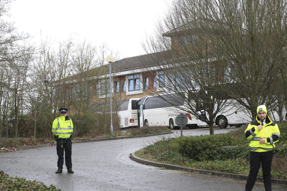 Coaches carrying people who have recently flown back from China arrive at Kents Hill Park Training and Conference Centre, in Milton Keynes, England, Sunday Feb. 9, 2020. Britain's evacuation plane, the second one charted by the government, arrived Sunday morning at RAF Brize Norton. British officials said the flight brought back 105 British citizens and family members, as well as 95 European citizens and family members. They will be quarantined for 14 days. (Aaron Chown/PA via AP)