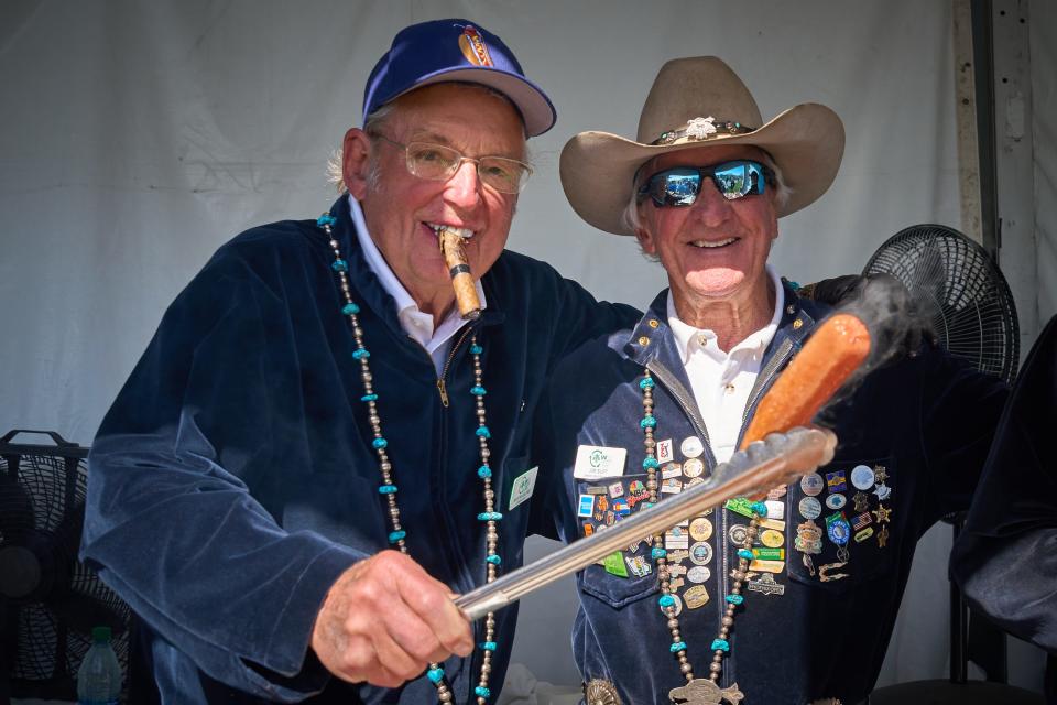 Feb 8, 2023; Scottsdale, AZ, USA; Martin Calfee, left, and Jim Suft pose for a photo while preparing Thunderdogs at the Lifebird Grill tent during the 2023 Annexus Pro-Am at TPC Scottsdale on Feb. 8, 2023. Mandatory Credit: Alex Gould/The Republic