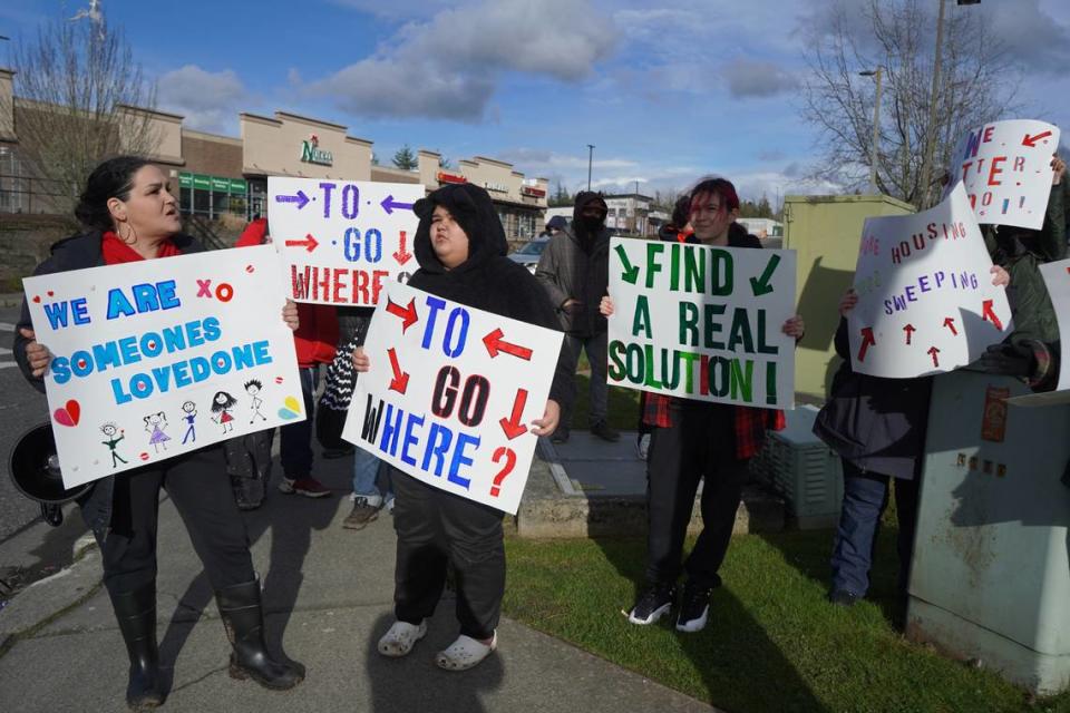 About 15 people gathered on March 9, 2024, to protest the impending clearing of the encampment behind Walmart in Bellingham, Wash. Protesters said they want more housing and services for the unhoused.