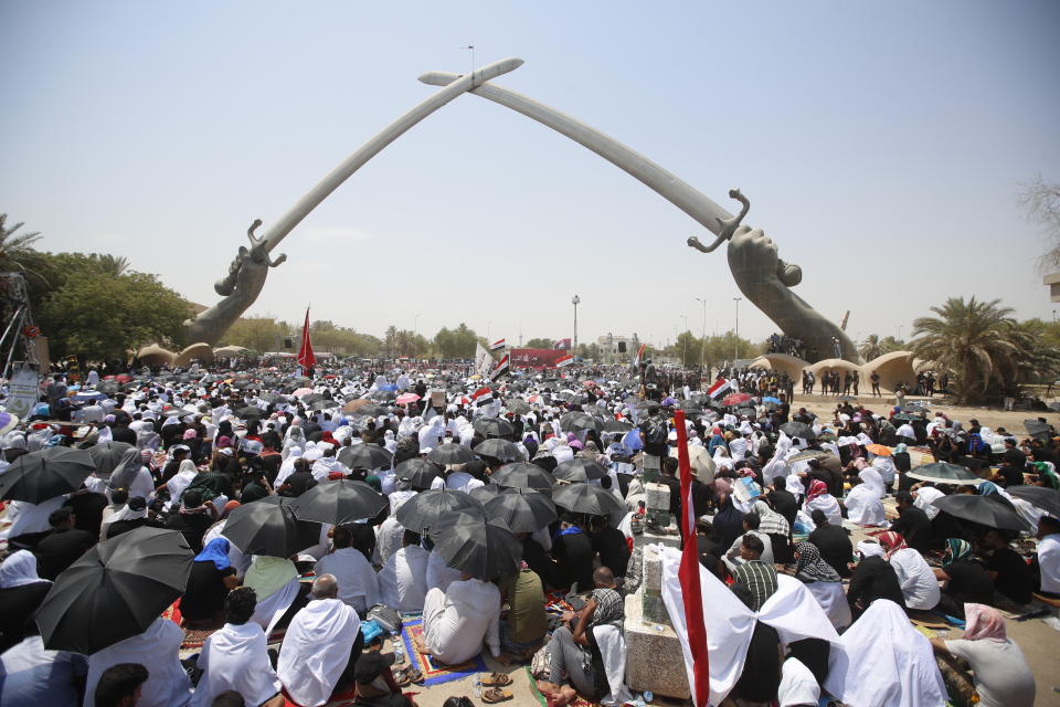 FILE - Followers of Shiite cleric Muqtada al-Sadr gather during an open-air Friday prayers at Grand Festivities Square within the Green Zone, in Baghdad, Iraq, Friday, Aug. 5, 2022. Al-Sadr is a populist cleric, who emerged as a symbol of resistance against the U.S. occupation of Iraq after the 2003 invasion. (AP Photo/Anmar Khalil, File)