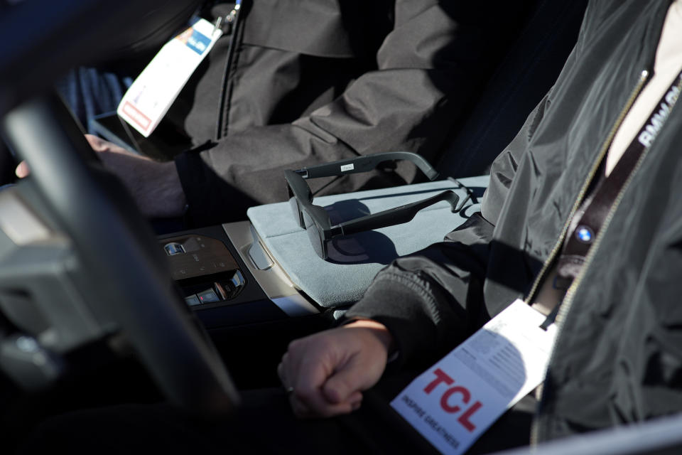 Xreal Air augmented reality glasses sit in a car during an augmented reality driving demonstration at the BMW booth during the CES tech show Wednesday, Jan. 10, 2024, in Las Vegas. (AP Photo/John Locher)