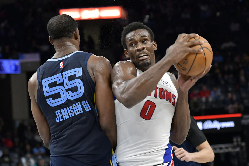 Detroit Pistons center Jalen Duren (0) handles the ball against Memphis Grizzlies center Trey Jemison (55) in the second half of an NBA basketball game Friday, April 5, 2024, in Memphis, Tenn. (AP Photo/Brandon Dill)