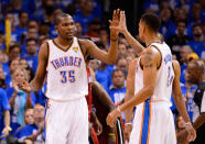 Kevin Durant and Thabo Sefolosha of the Oklahoma City Thunder give each other a high five in the third quarter in Game One of the 2012 NBA Finals at Chesapeake Energy Arena on June 12, 2012 in Oklahoma City, Oklahoma. (Photo by Ronald Martinez/Getty Images)