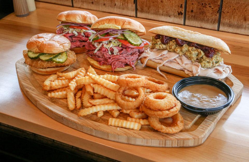 A platter of some of the customer favorites at Miller's Famous Sandwiches. They include roast beef, a Thanksgiving sandwich, fried chicken, crinkle fries and onion rings.