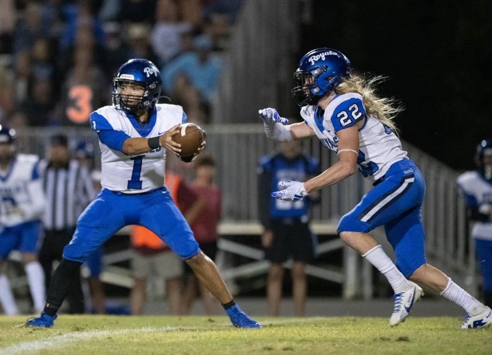 Quarterback Hayden Morris (1) looks to handoff to Brock Stout (22) during the Jay vs Northview football game at Northview High School in Century on Friday, Oct. 13, 2023.