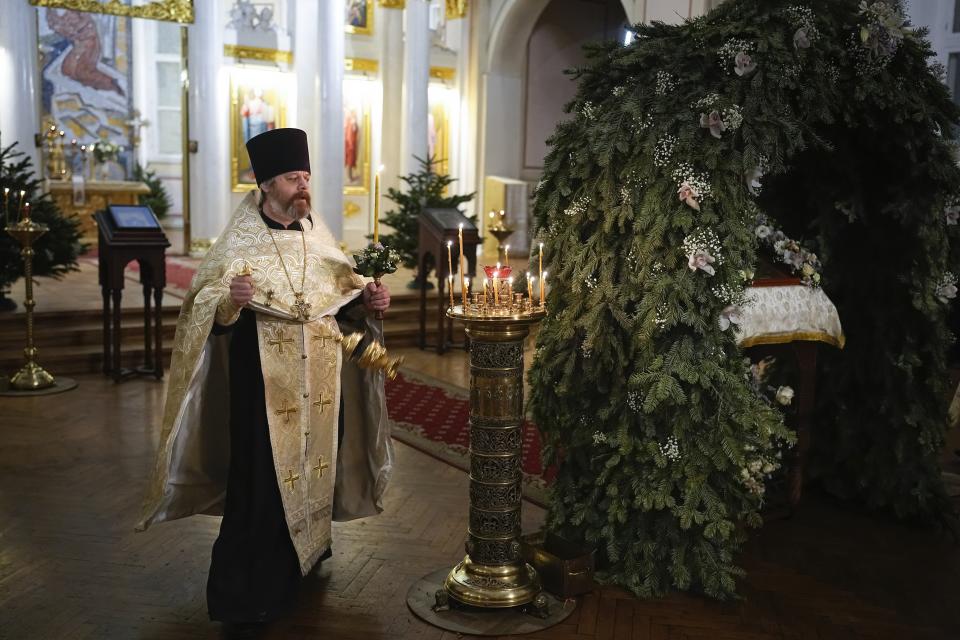 A Russian Orthodox Church priest takes part in an Orthodox Christmas service at the Church of the Holy Martyr Tatiana near the Kremlin Wall in Moscow, Russia, late Saturday, Jan. 6, 2024. (AP Photo/Alexander Zemlianichenko)