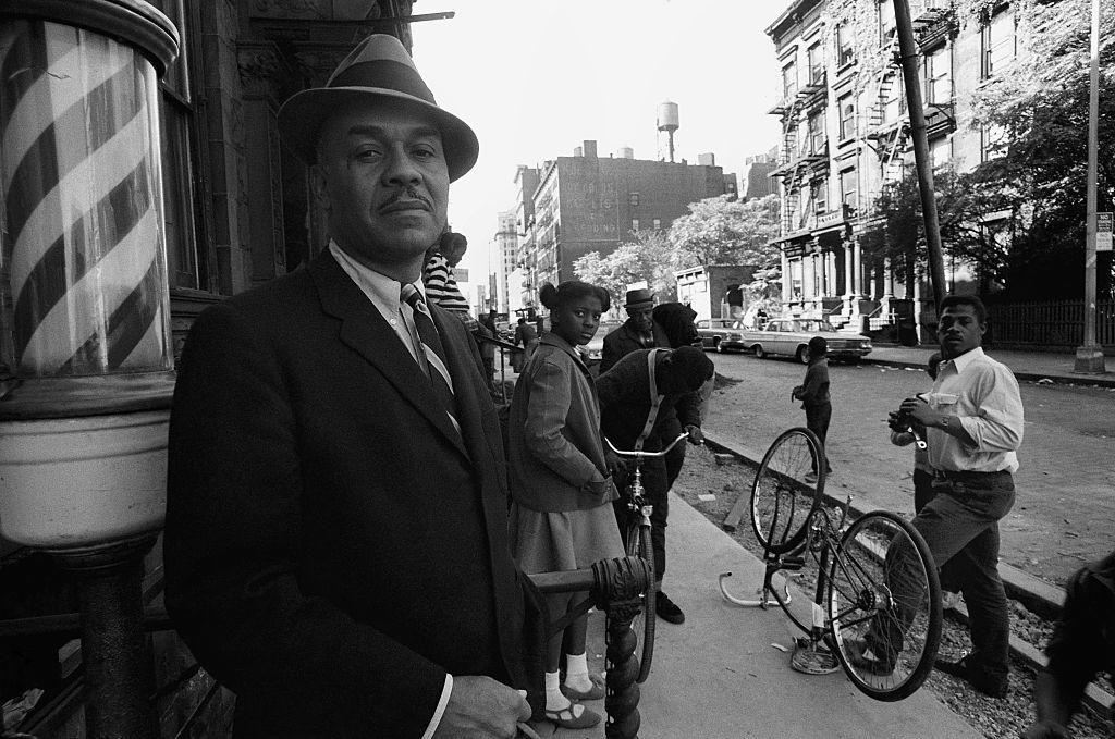 “I am invisible, understand, simply because people refuse to see me,” says the narrator of <em>Invisible Man</em>, written by Ralph Ellison, snapped here in Harlem, NYC, in 1966. (Credit: David Attie/Getty Images)