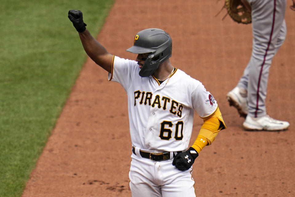 Pittsburgh Pirates' Liover Peguero celebrates at first base after driving in a run with a single off Atlanta Braves relief pitcher Brad Hand during the seventh inning of a baseball game in Pittsburgh, Thursday, Aug. 10, 2023. (AP Photo/Gene J. Puskar)