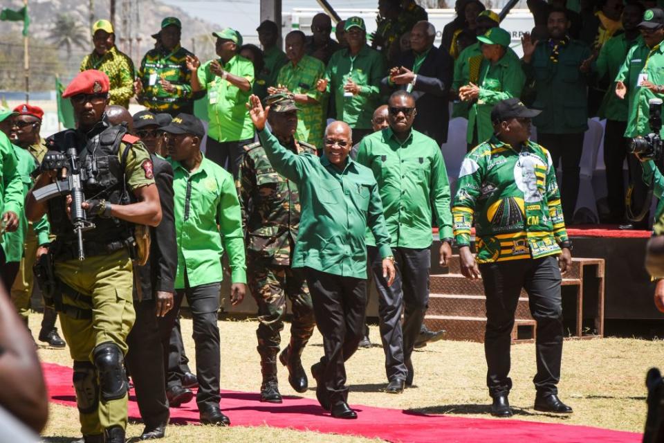 Tanzania's incumbent President and presidential candidate of ruling party Chama Cha Mapinduzi (CCM) John Magufuli (C) waves as he arrives to give a speech during the official launch of the party's campaign for the October general election at the Jamhuri stadium in Dodoma, Tanzania.