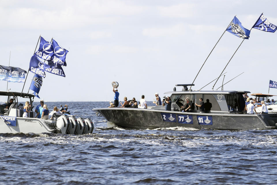 The Stanley Cup is held up as the Tampa Bay Lightning celebrate their NHL hockey Stanley Cup victory with a boat parade Monday, July 12, 2021 in Tampa, Fla. (Dirk Shadd/Tampa Bay Times via AP)