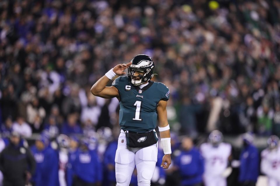 Philadelphia Eagles quarterback Jalen Hurts reacts after throwing a touchdown pass to wide receiver DeVonta Smith during the first half of an NFL divisional round playoff football game against the New York Giants, Saturday, Jan. 21, 2023, in Philadelphia. (AP Photo/Matt Slocum)