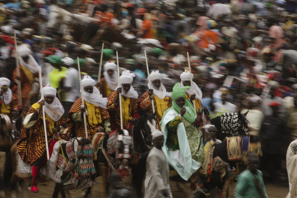 People ride on a horse back during a Durbar festival to celebrate Eid al-Fitr and the end of Ramadan in Zazzau , Nigeria, Saturday, May 15, 2021. (AP Photo/Fati Abubakar)