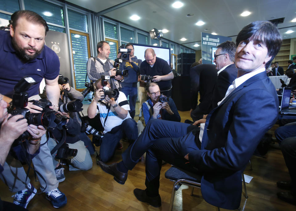 Coach of German national soccer team Joachim Loew waits for the beginning of a press conference where he presented his preliminary team for the upcoming World Cup in Brazil in Frankfurt, Germany, Thursday, May 8, 2014. (AP Photo/Michael Probst)