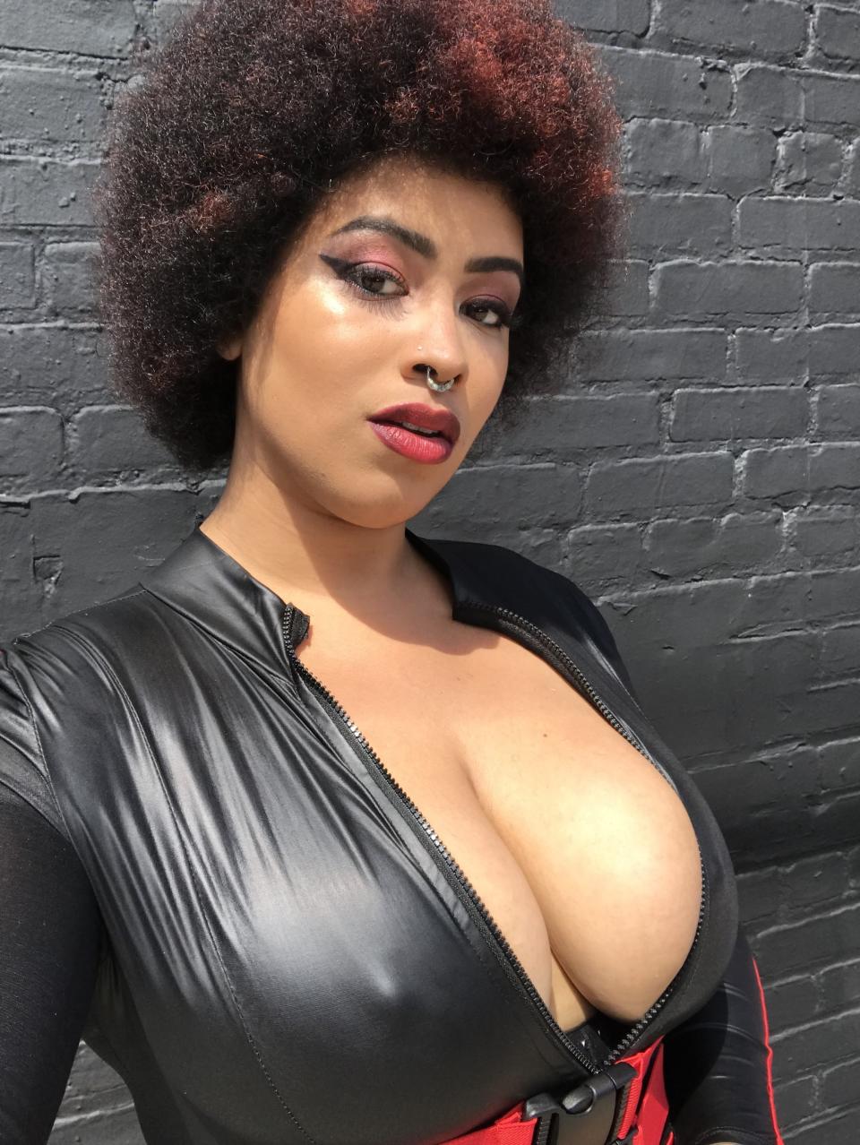 Black woman with afro in latex jumpsuit