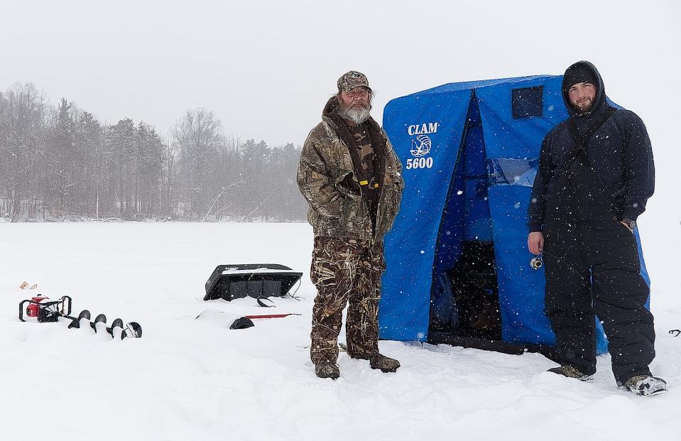 Springfield resident Rick Copeland, left, and his son Eric Copeland, of Tallmadge, took a day to catch some fish in their ice hut on Mogadore Reservoir Monday.