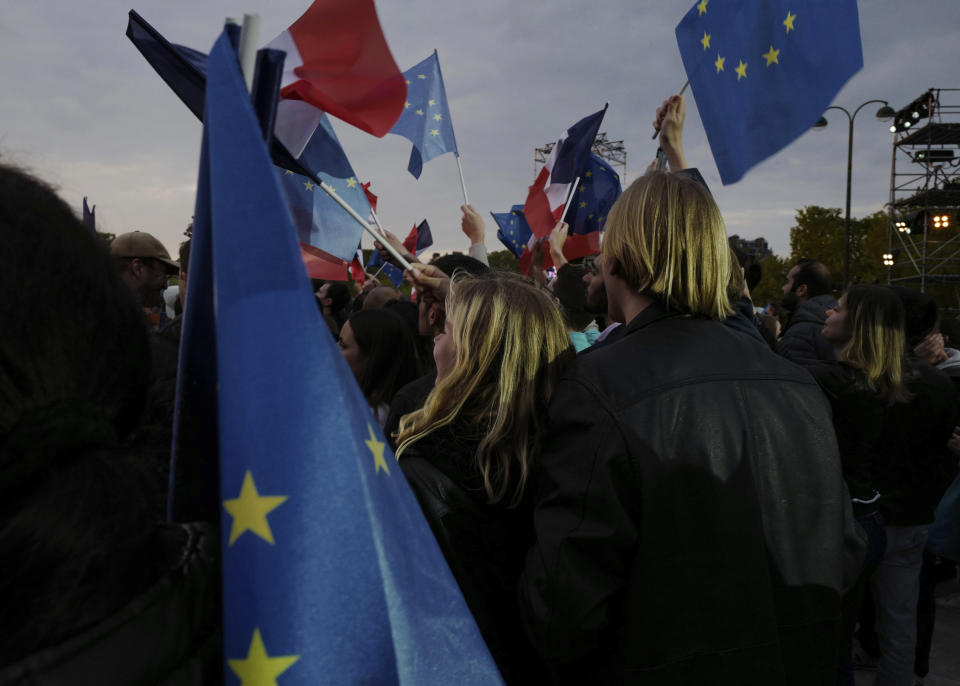 Supporters of French President Emmanuel Macron wait to hear his election night speech in Paris, France, Sunday, April 24, 2022. Polling agencies projected that French President Emmanuel Macron comfortably won reelection in the presidential runoff, offering French voters and the European Union the reassurance of leadership stability in the bloc's only nuclear-armed power as the continent grapples with Russia's invasion of Ukraine. (AP Photo/Rafael Yaghobzadeh)