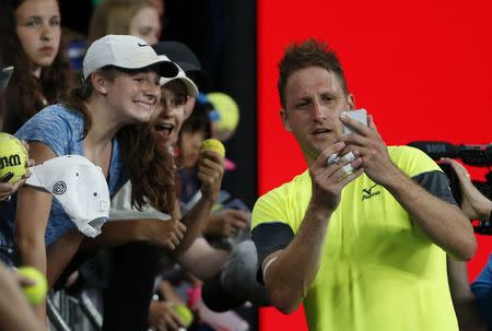 Tennis - Australian Open - Hisense Arena, Melbourne, Australia, January 22, 2018. Tennys Sandgren of the U.S. takes a photo with fans after winning his match against Austria's Dominic Thiem. REUTERS/Toru Hanai