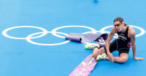 Nicola Spirig of Switzerland falls after winning gold in the Women's Triathlon on Day 8 of the London 2012 Olympic Games at Hyde Park on August 4, 2012 in London, England. (Getty Images)