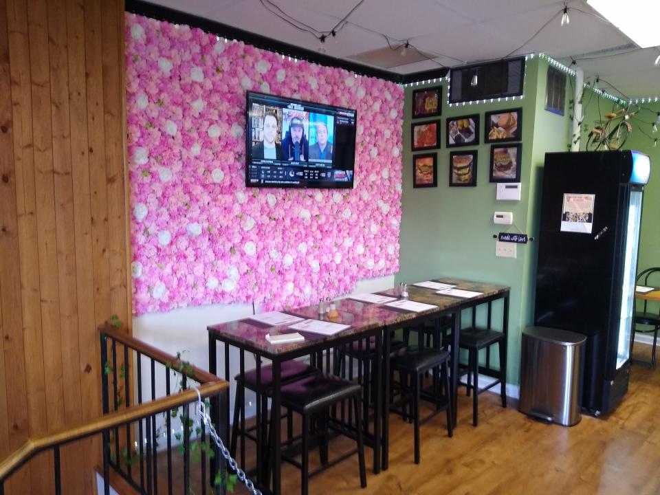 A floral pattern accents a wall at the Soulful Vegan in Akron.