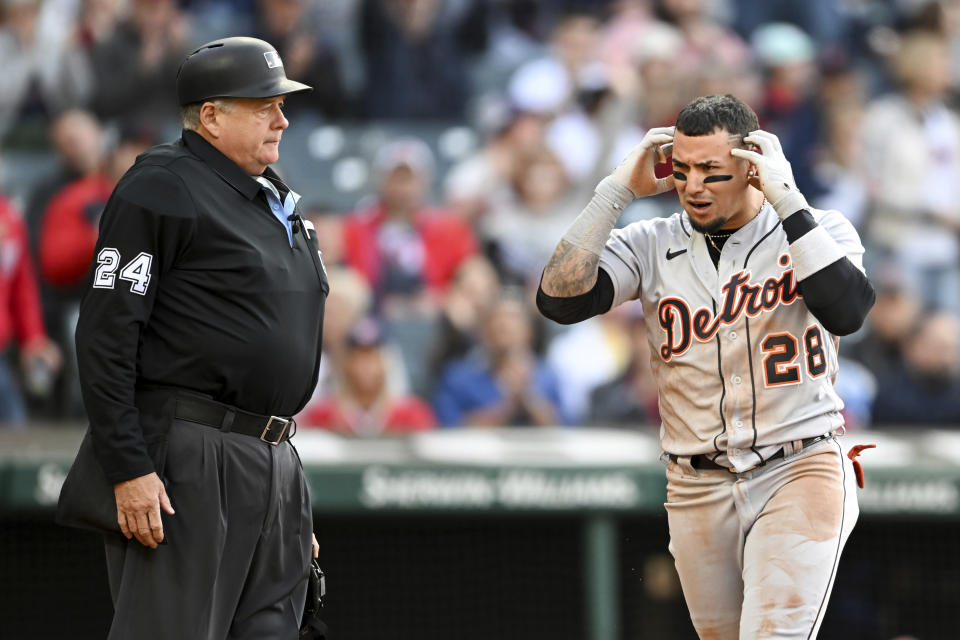 Detroit Tigers' Javier Báez (28) calls for a replay by home plate umpire Jerry Layne after being tagged out at home plate by Cleveland Guardians' Cam Gallagher during the third inning of a baseball game, Tuesday, May 9, 2023, in Cleveland. (AP Photo/Nick Cammett)