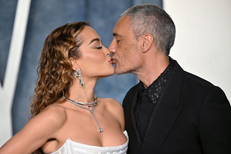 Taika Waititi (R) and wife Rita Ora share a kiss as they arrive for the Vanity Fair Oscar Party at the Wallis Annenberg Center for the Performing Arts in Beverly Hills, Calif., on March 12. File Photo by Chris Chew/UPI