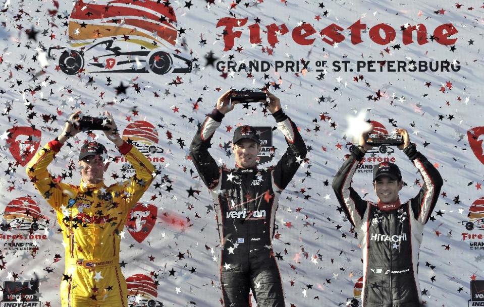 Race winner Will Power, center, of Australia, poses with second-place finisher Ryan Hunter-Reay, left, and third-place finisher Helio Castroneves, right, of Brazil, in Victory Circle after the IndyCar Grand Prix of St. Petersburg auto race, Sunday, March 30, 2014, in St. Petersburg, Fla. (AP Photo/Chris O'Meara)