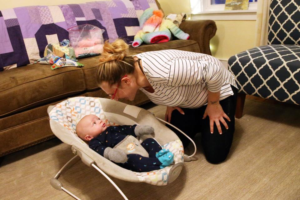 Megan LaChapelle smiles at her 3-month-old son in the living room at Hope on Haven Hill, a residential program for pregnant women and new mothers grappling with substance use disorder. LaChapelle says this is the first time in her life she has been sober, and she's excited for her future with her son.