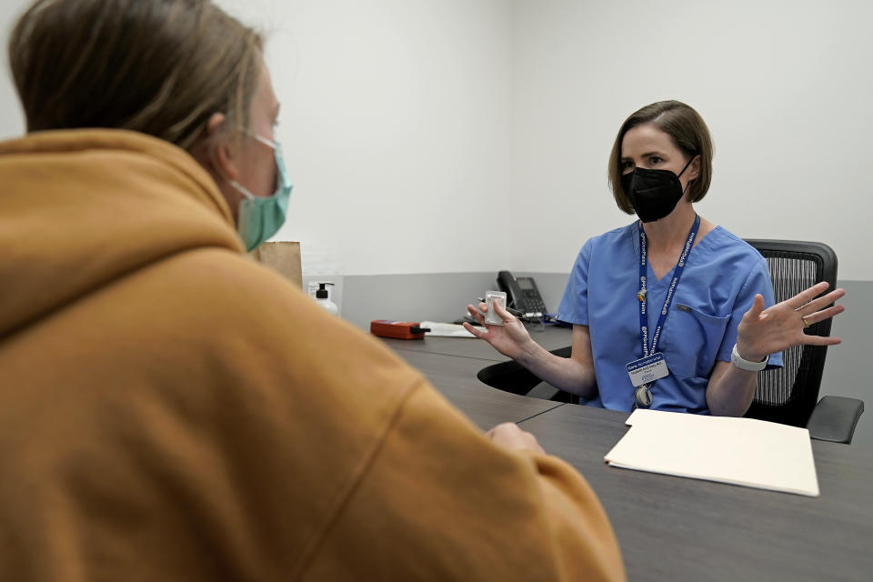 Dr. Elizabeth Brett Daily talks with patient Haley Ruark about the medical abortion process at a Planned Parenthood clinic Wednesday, Oct. 12, 2022, in Kansas City, Kan. (AP Photo/Charlie Riedel)