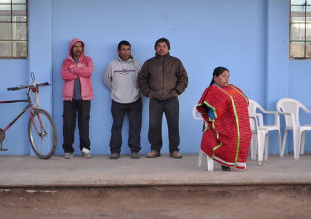 Martha Bautista (R) sits on a chair on a sidewalk in the neighborhood of New Copala in San Quintin, Mexico, November 19, 2015. REUTERS/Alasdair Baverstock