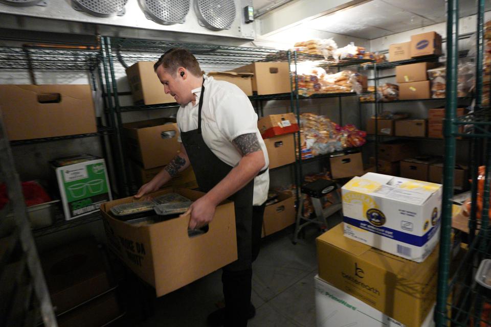 Homeless Alliance Chef Chris McDermitt moves items around recently inside a walk-in refrigerator at the Homeless Alliance day shelter in Oklahoma City.