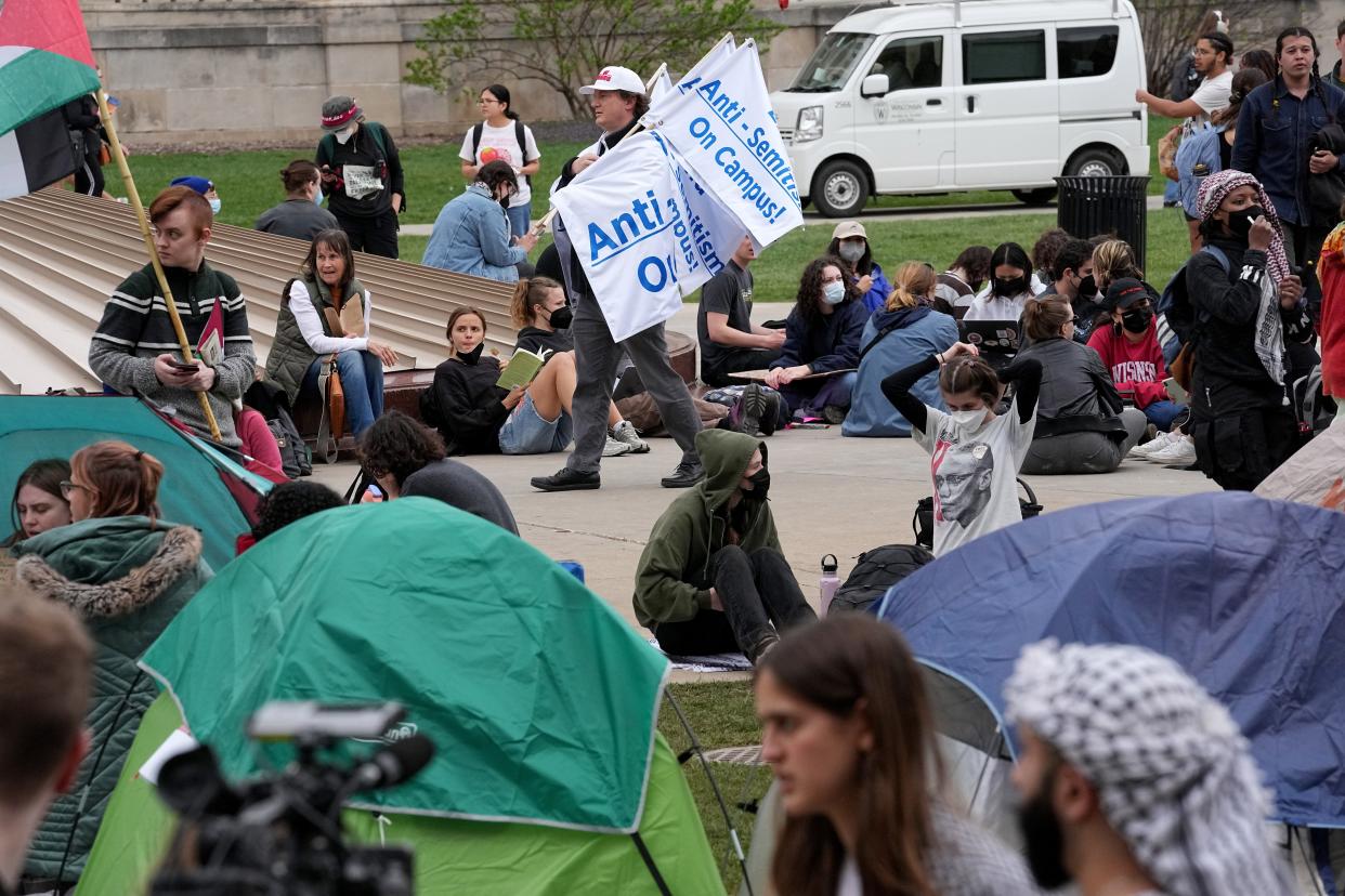 A man protests people protesting the Israel-Hamas war Monday at the University of Wisconsin-Madison.