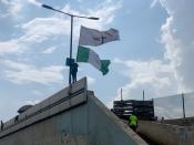 Adebanjo Akinwunmi raises his flags as Nigeria marks the first anniversary of the EndSARS anti-police brutality protests in Lagos