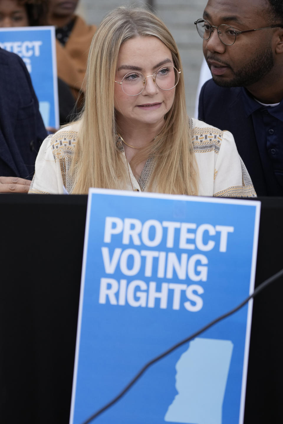 Brittany Denson, a poll monitor, recalls problems a number of Hinds County precincts encountered during the general election in November, at a news conference in Jackson, Miss., on Thursday, Dec. 7, 2023, (AP Photo/Rogelio V. Solis)